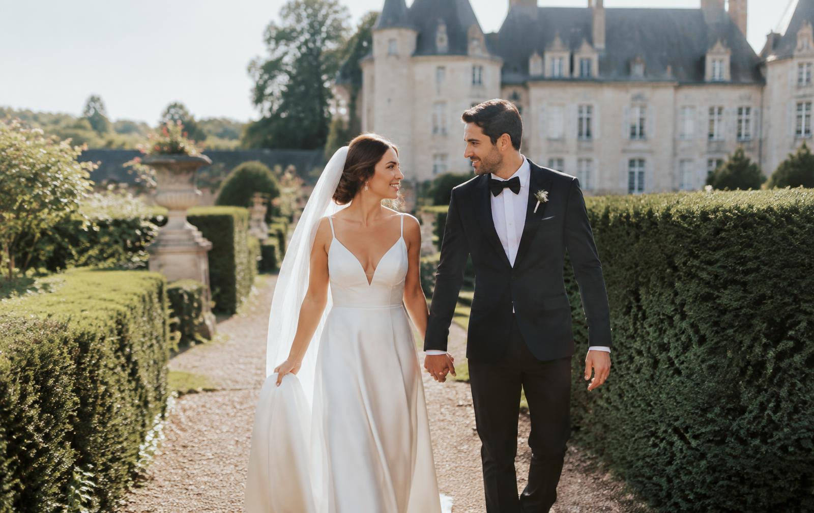 Couple walking through a château garden